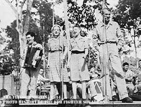 Arcari, Brooks, Merkel, and Cooper on stage at USO Show